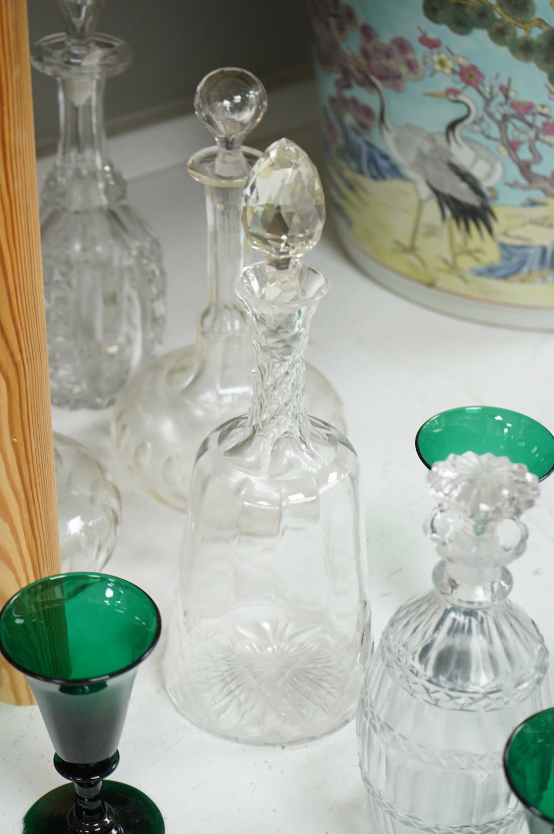 A set of four 19th century Bristol green glasses, an early 19th century spirit decanter and other Victorian decanters